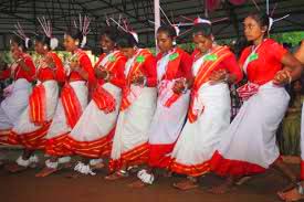 Sacred Karam tree branch worship ritual with flowers and lamps